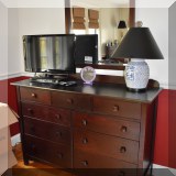 F53. Double dresser and matching mirror. Dresser: 40”h x 55.5”w x 19”d 